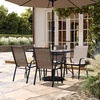 image:imageFlash Furniture Brazos Commercial Outdoor Dining Set 47 Tempered Glass Patio Table with Umbrella Hole 4 Stack Chairs with Flex Comfort Seats and Backs BlackBlackBrown
